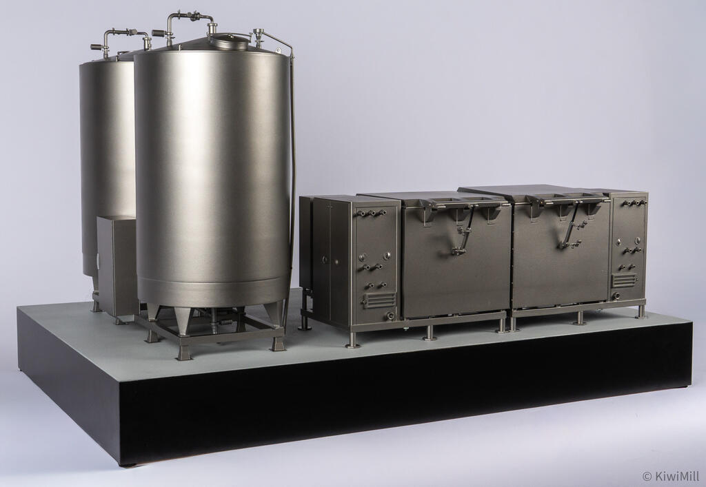 Rear elevation at an angle showing the cook tank's hinge arms, side vents and pipe connections on the end cabinets